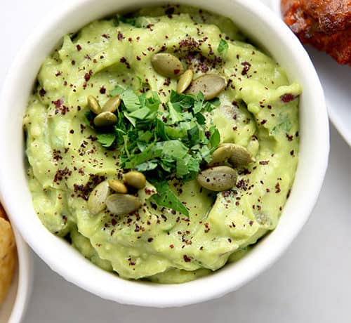 creamy guacamole with tangy sumac and crunchy pumpkin seeds